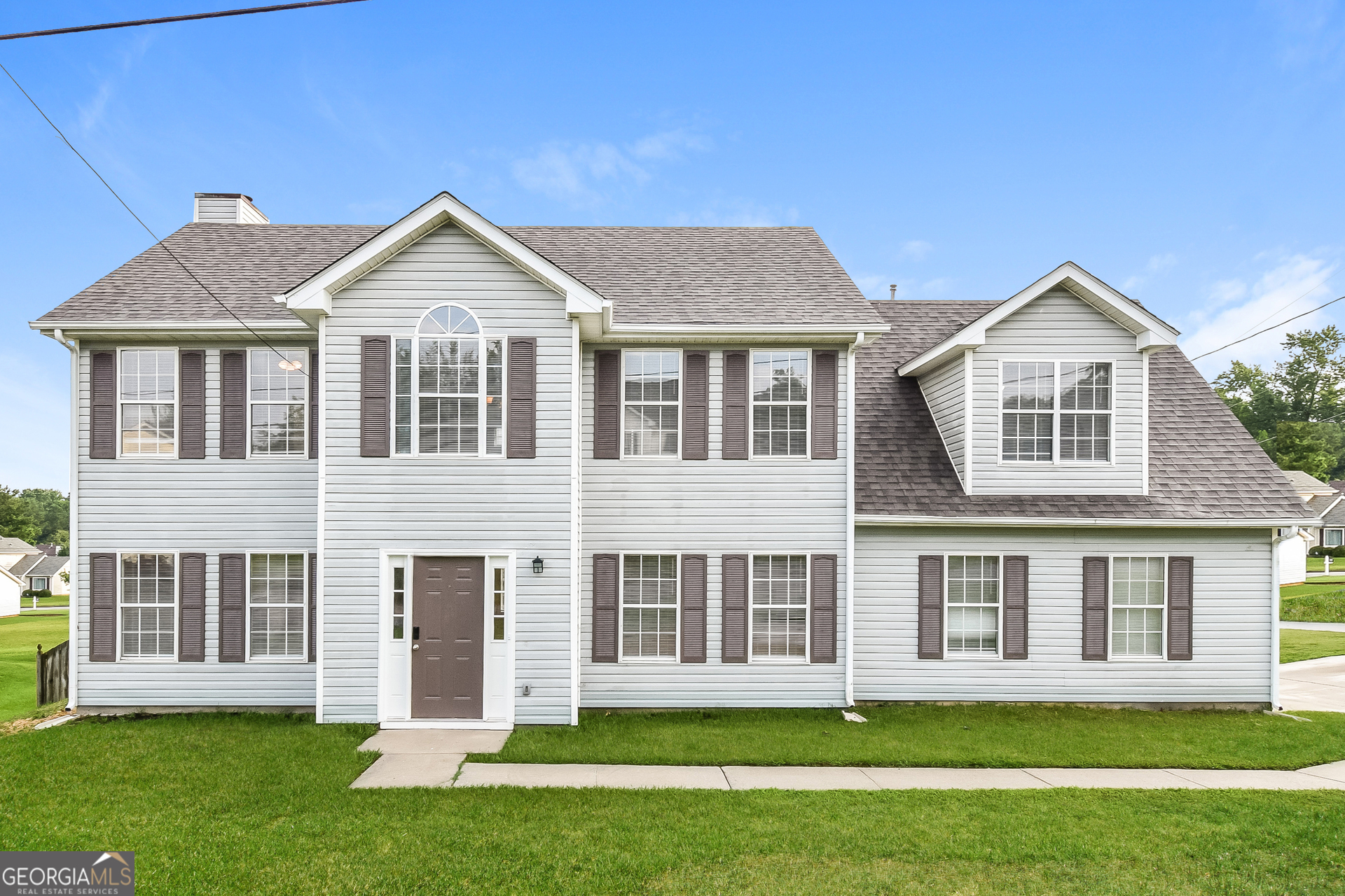 a front view of a house with a yard