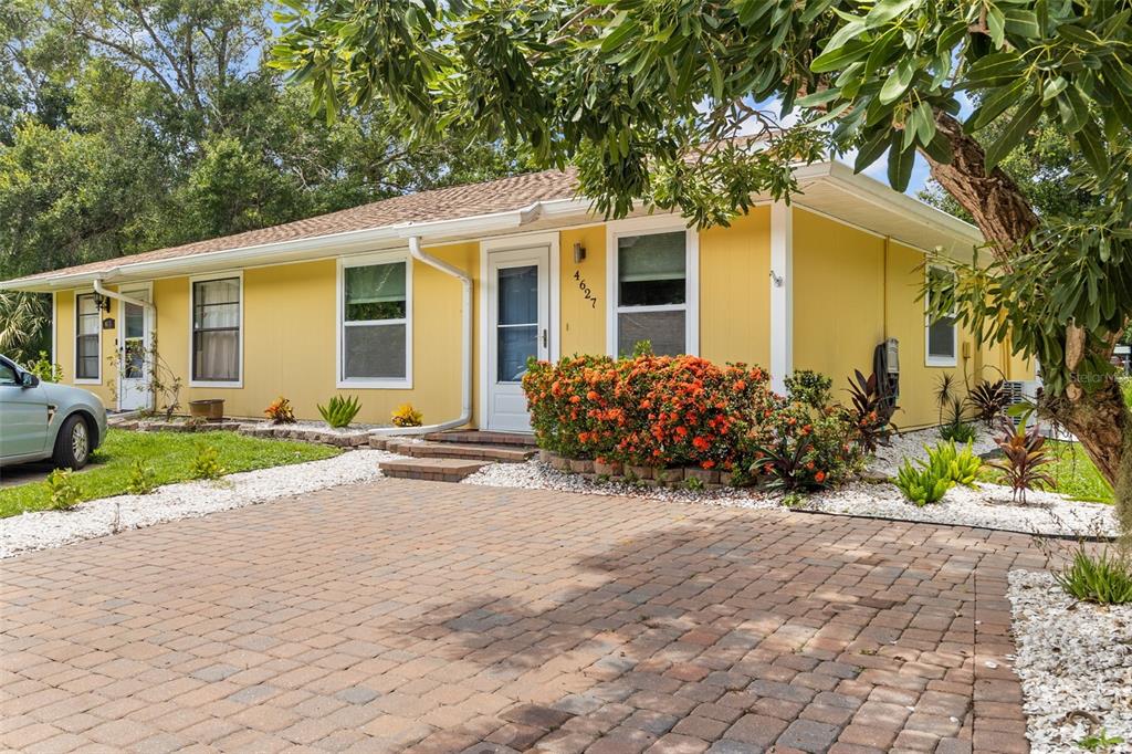 a front view of a house with a yard and a garage