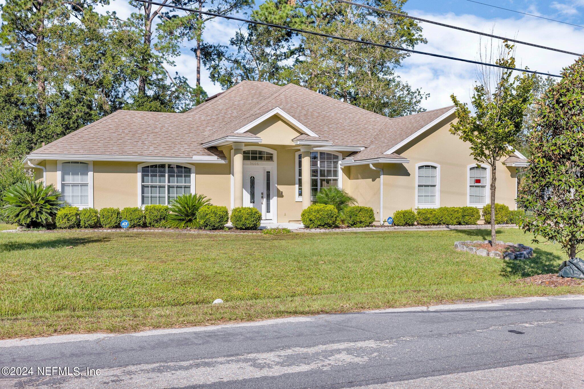 a front view of a house with a garden