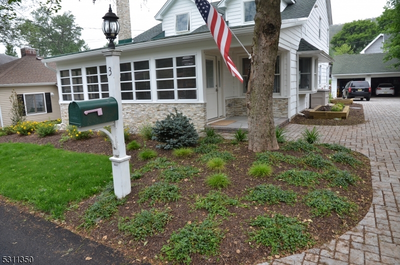 a front view of a house with garden and porch