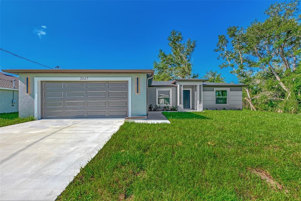 a front view of house with yard and green space