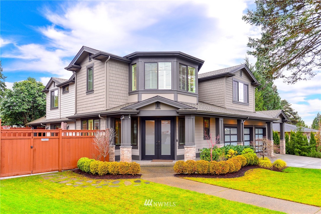 a front view of a house with yard porch and glass windows