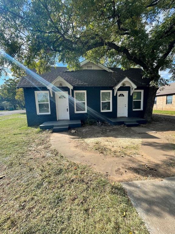 a house that has a tree in front of it