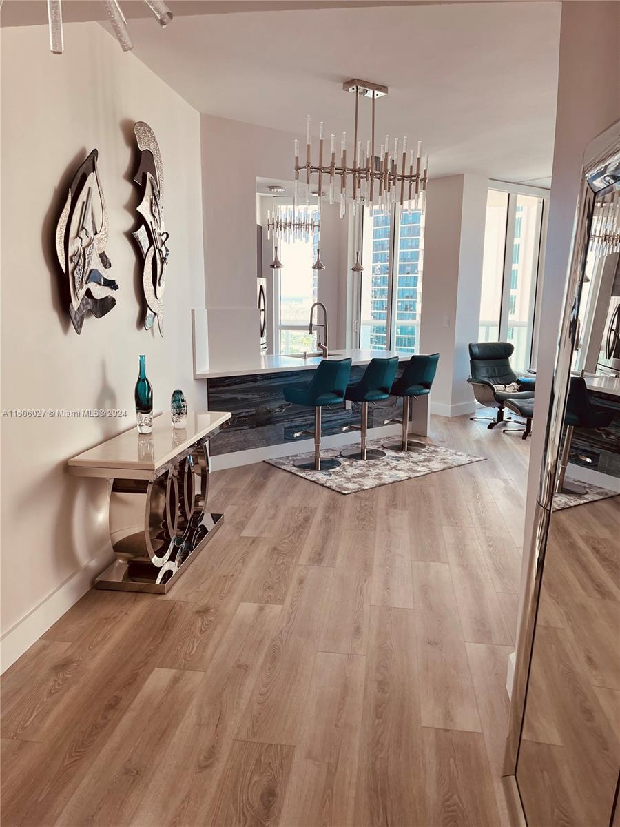 a living room with furniture and a chandelier