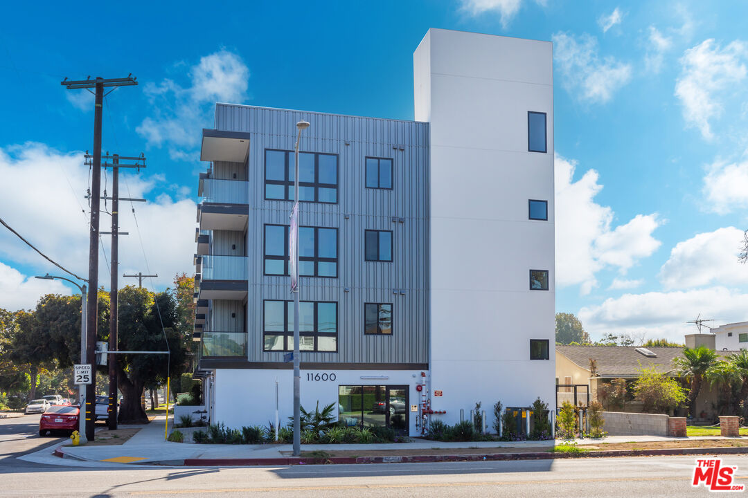 a view of a tall building next to a road