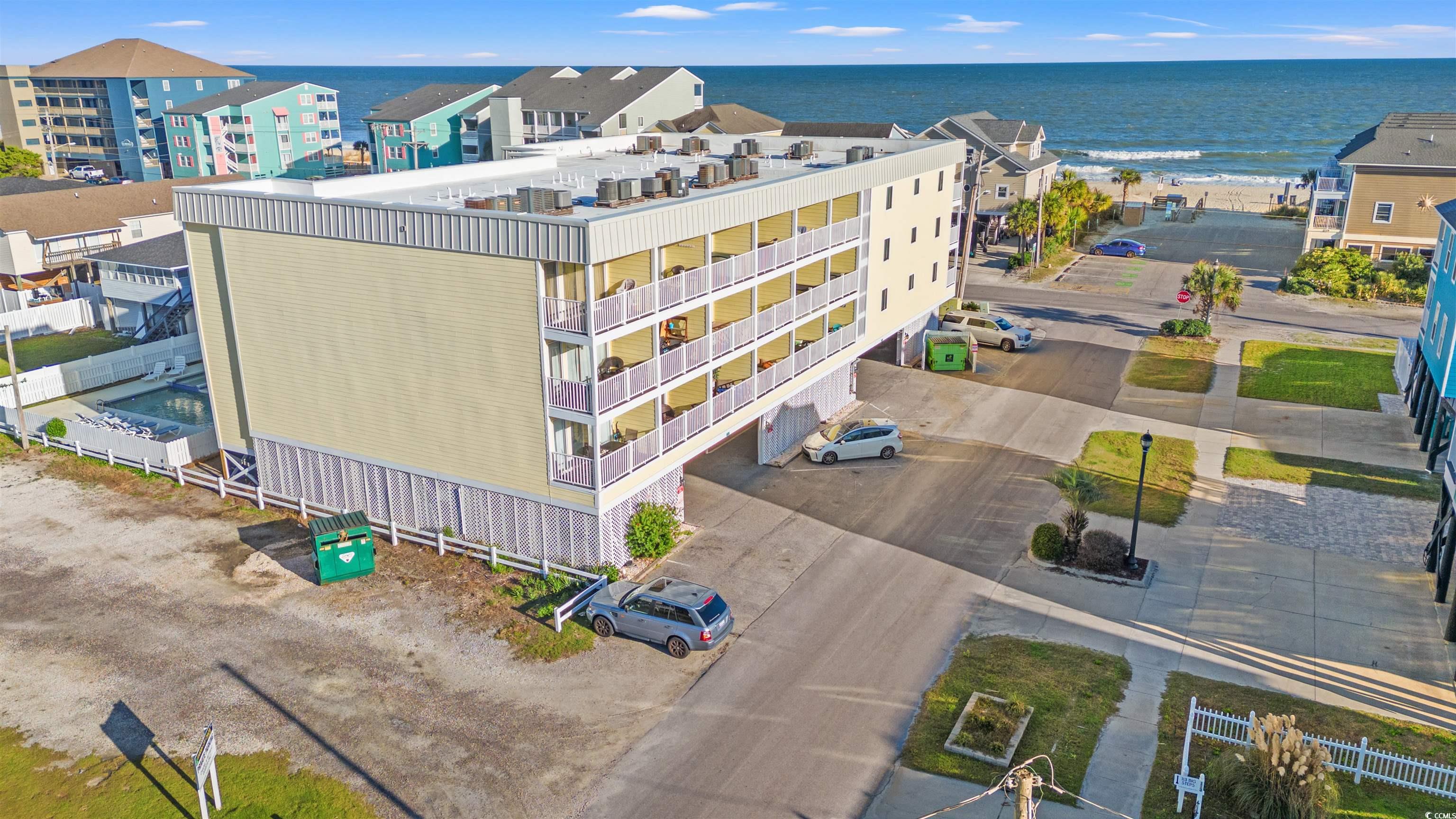 Birds eye view of property with a water view