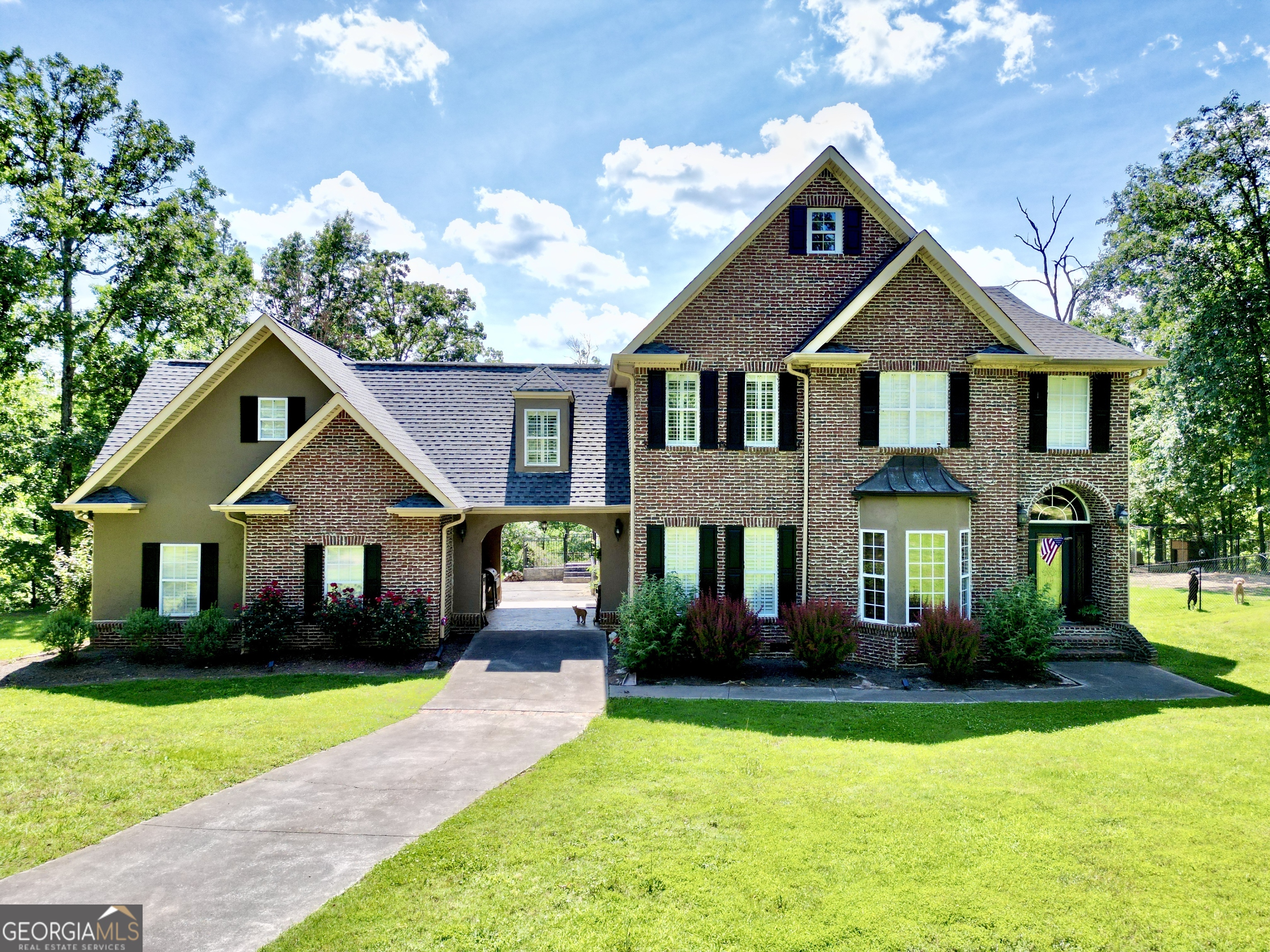 a front view of a house with garden