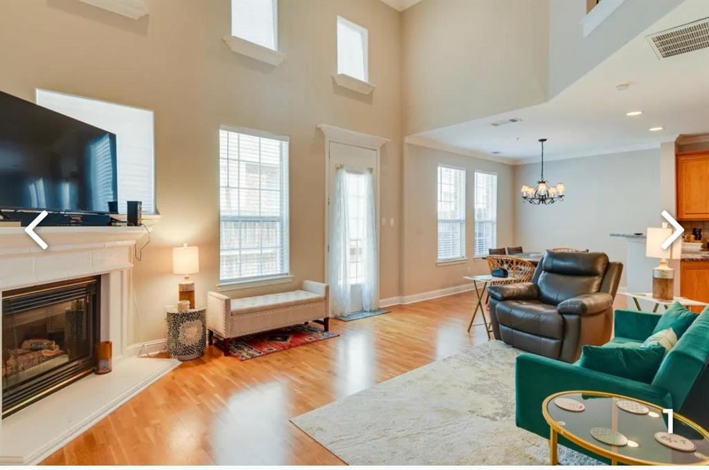 a living room with furniture flat screen tv and a fireplace