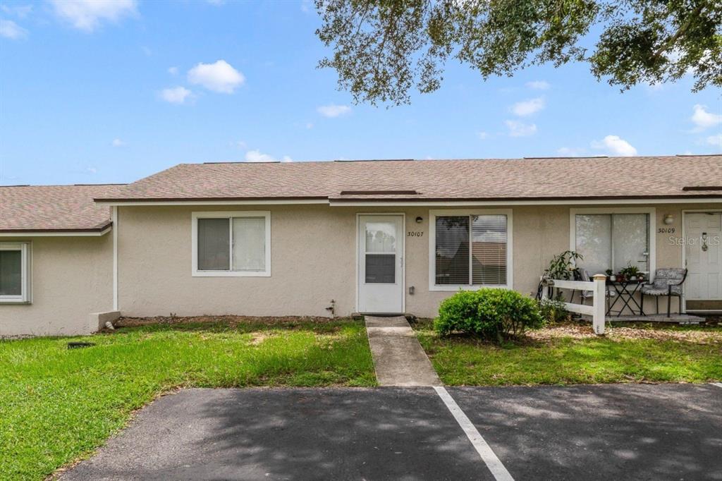 Welcome to Tavares Ridge and this bright OPEN CONCEPT ~ SINGLE STORY ~ 3BD/2BA UNIT with a NEW A/C (2024), TILE FLOORS THROUGHOUT and a retention pond behind for no immediate rear neighbors! 