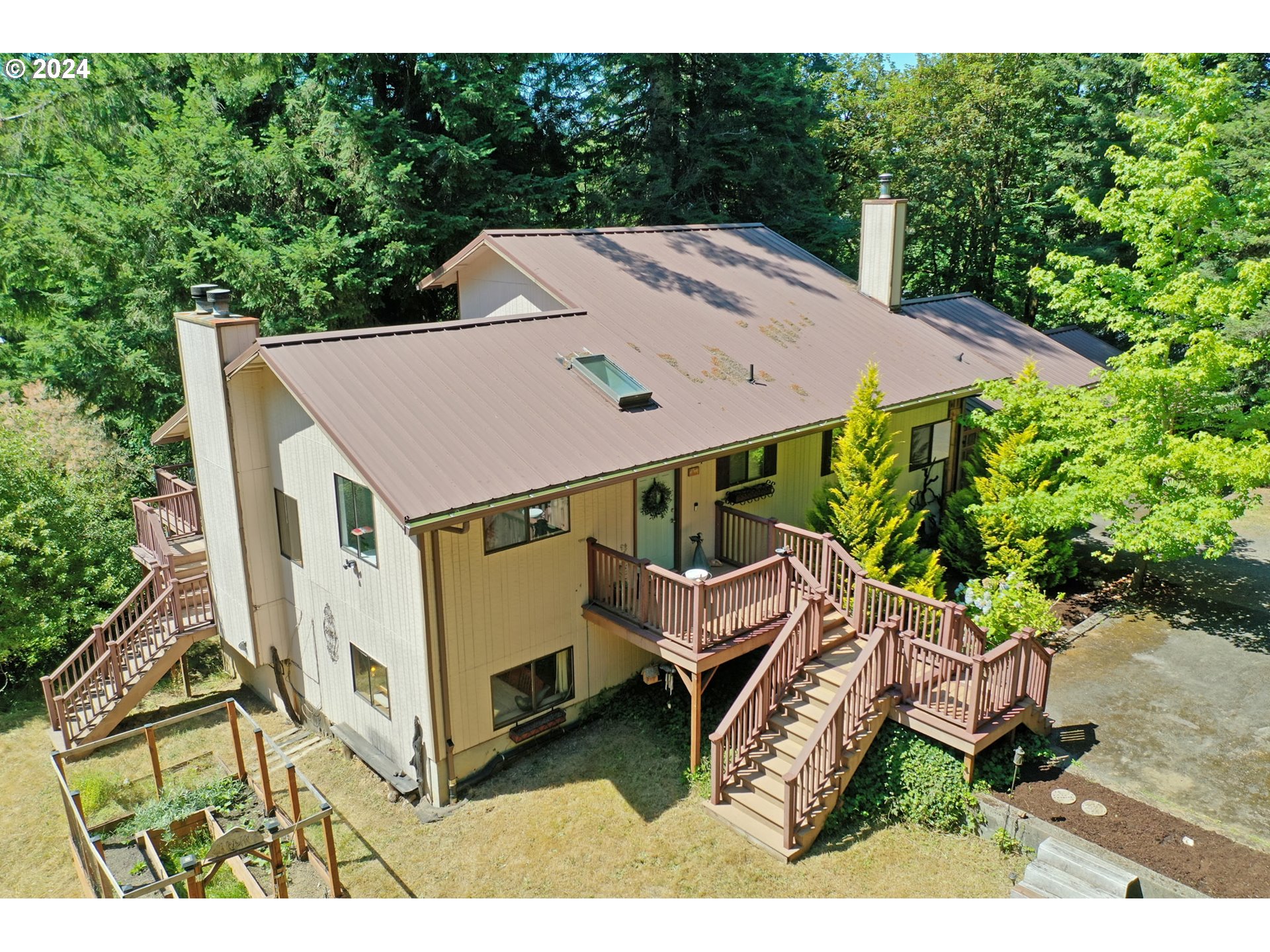 a aerial view of a house with a yard and sitting area