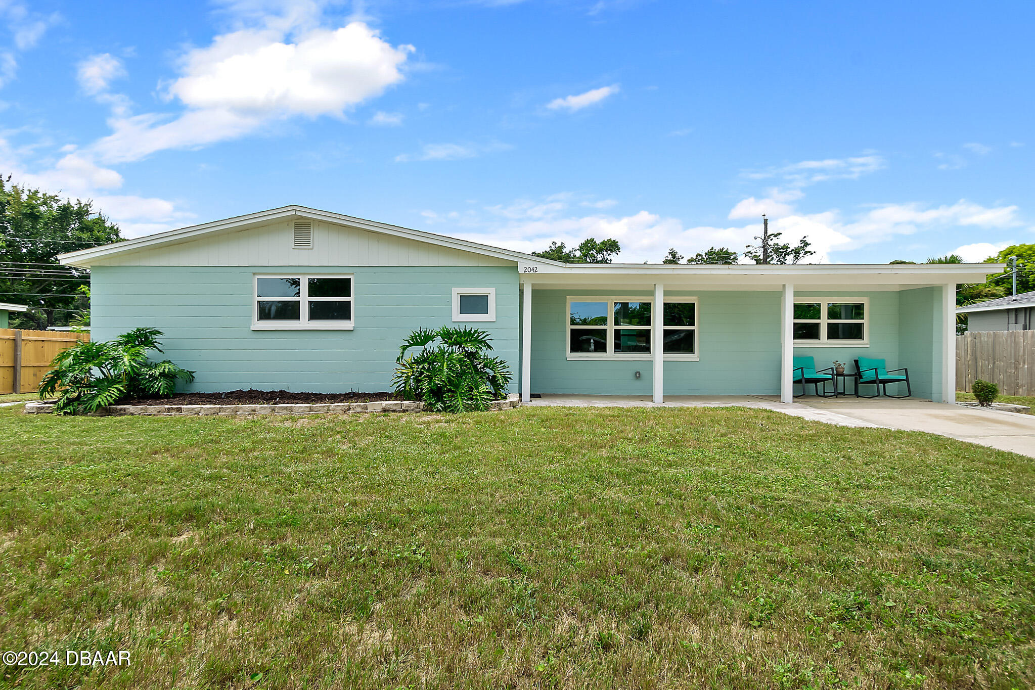 a front view of house with yard and green space