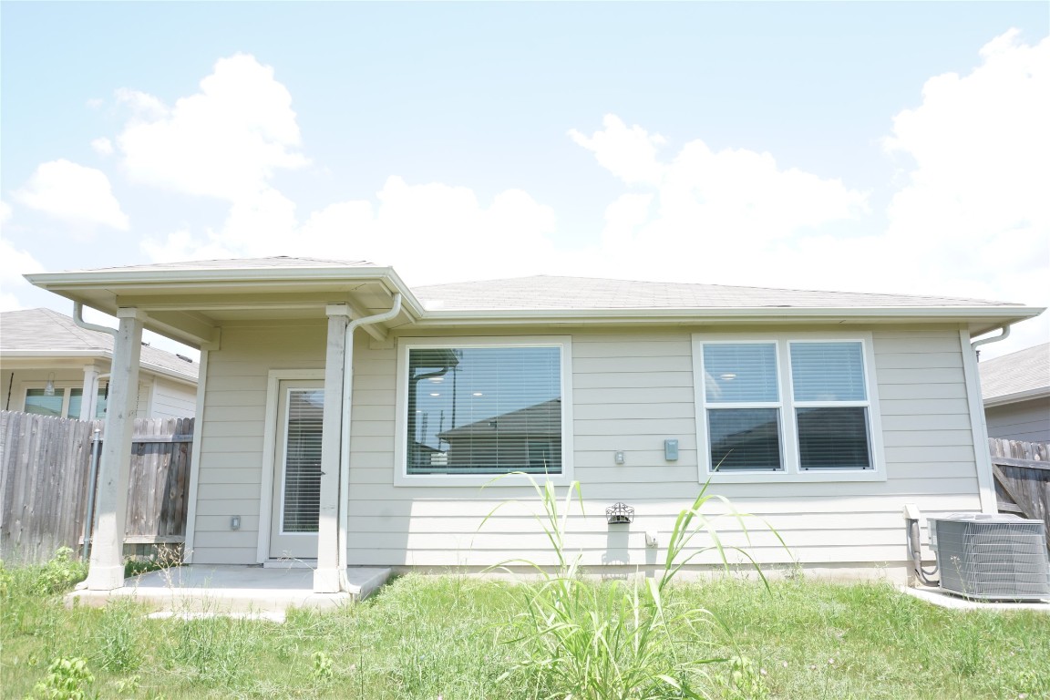 a view of house with backyard space and balcony