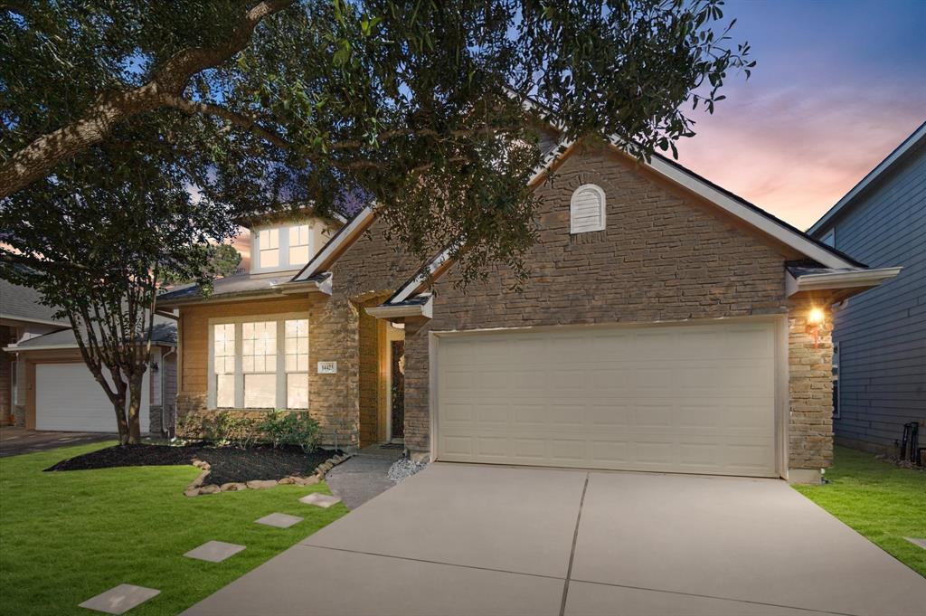 a front view of a house with a yard and garage