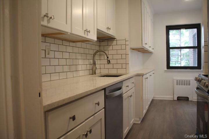 a kitchen with a sink and cabinets