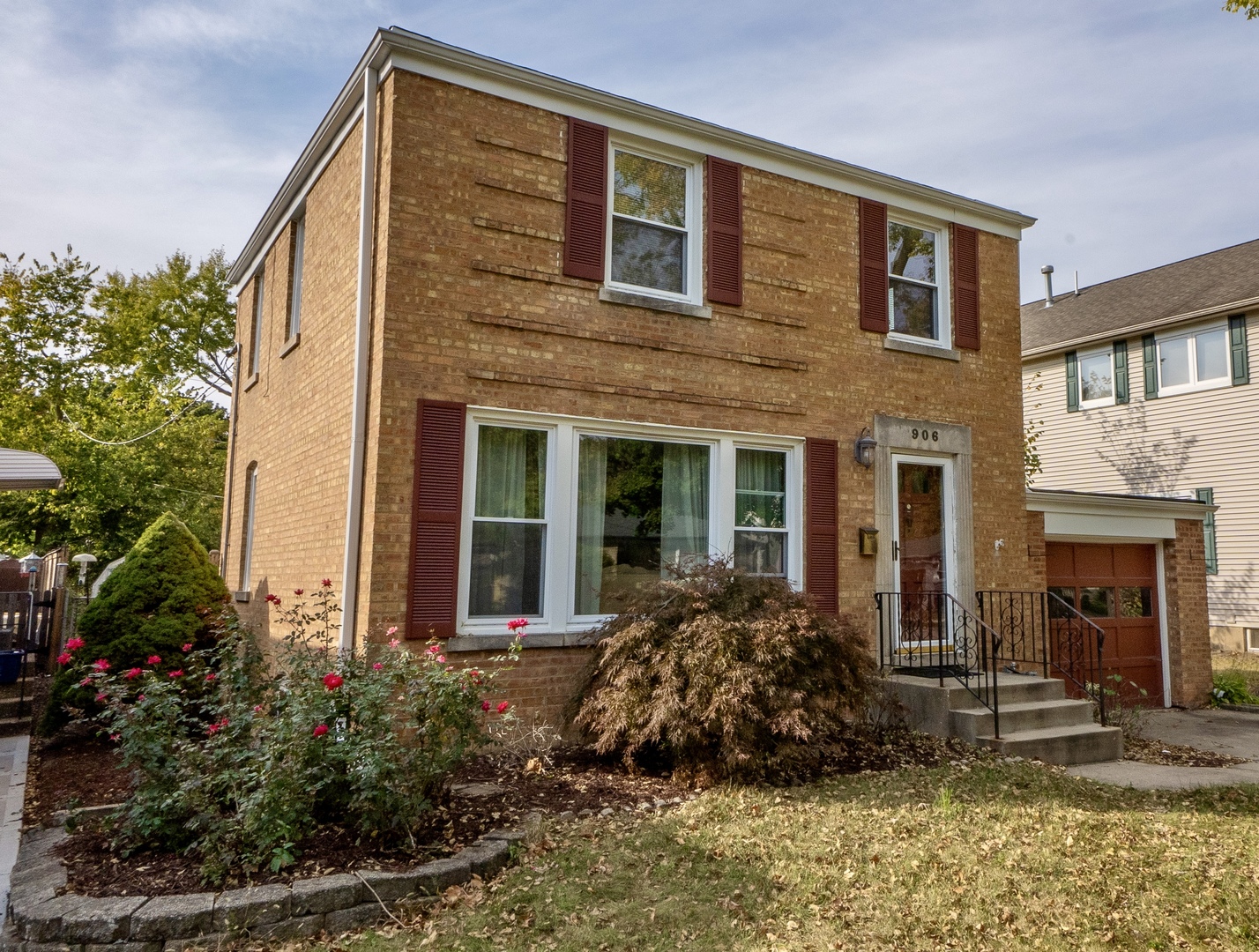 front view of a brick house with a small yard