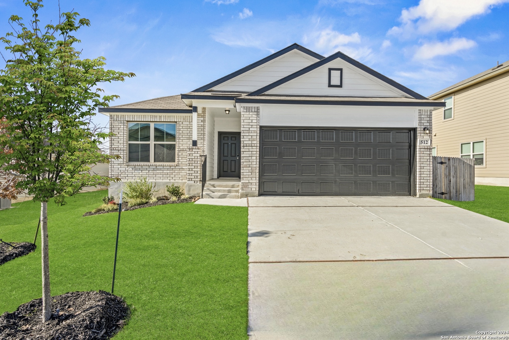 a front view of a house with a yard and garage