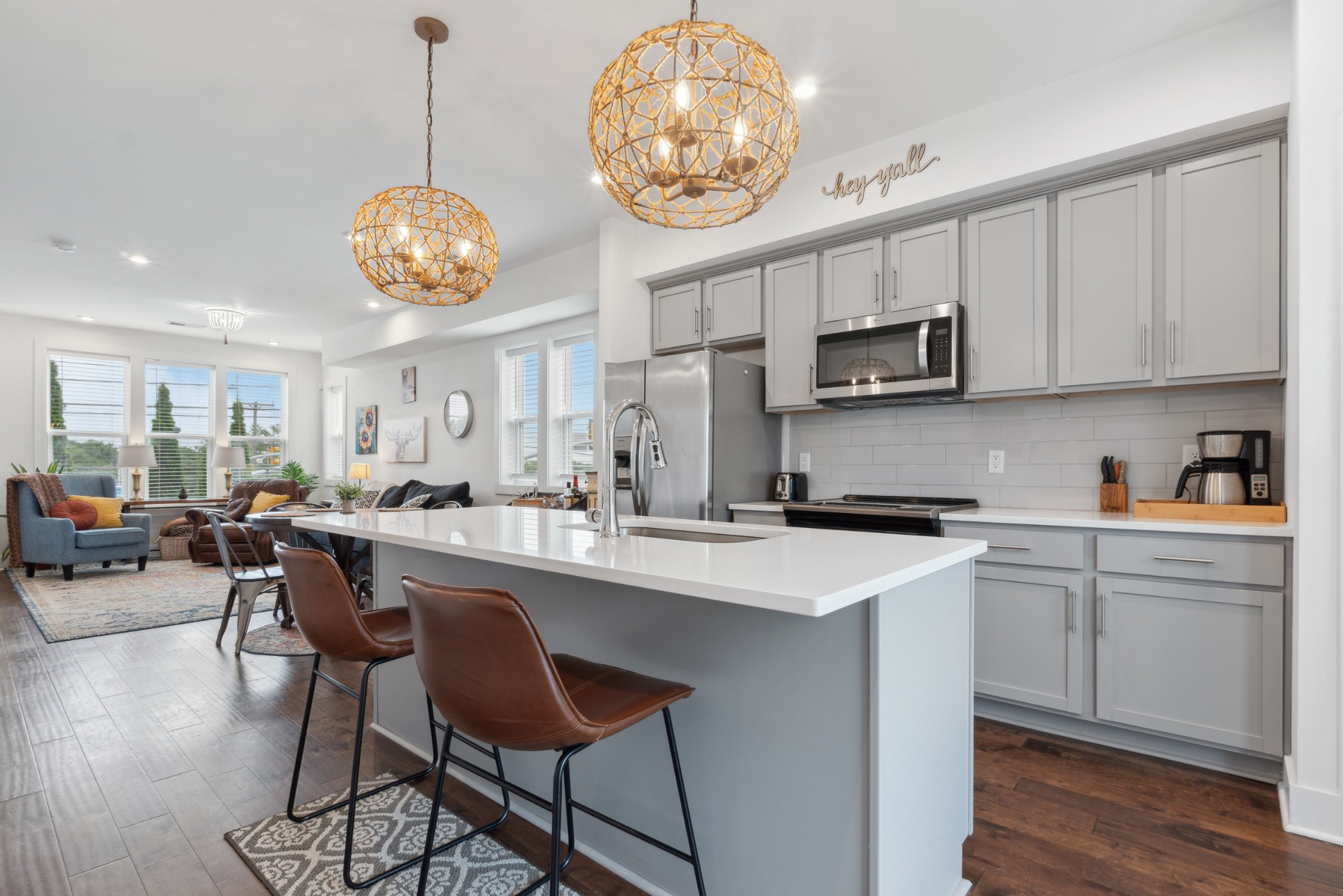 a kitchen with stainless steel appliances a table chairs and a chandelier
