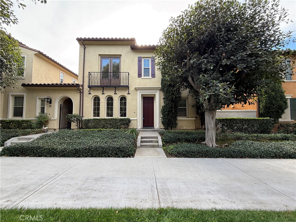 a front view of a house with garage and plants