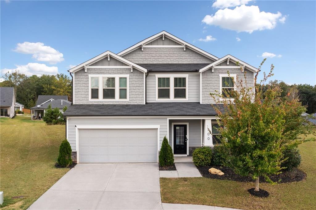 a front view of a house with a yard and garage