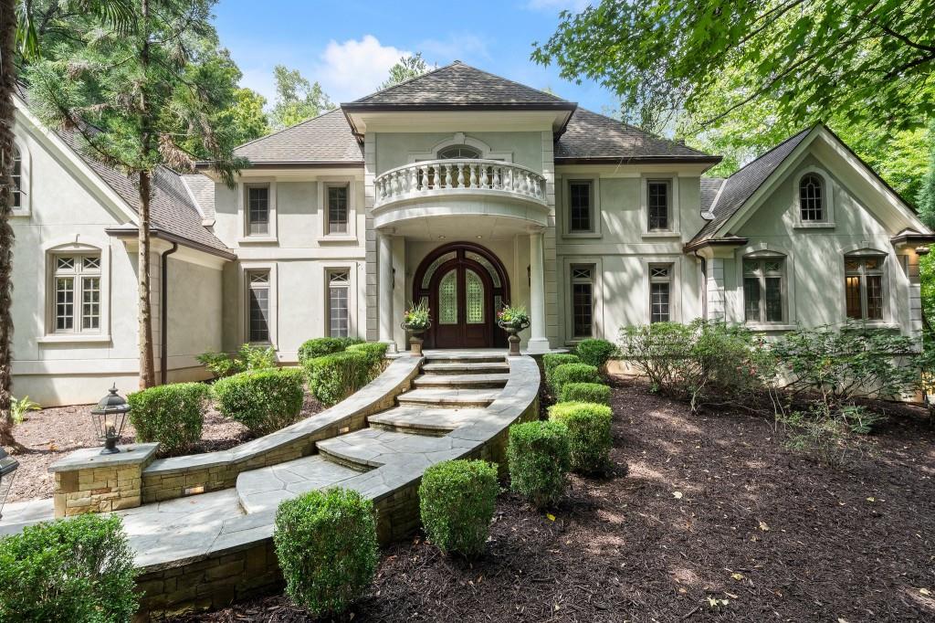 a front view of a house with garden