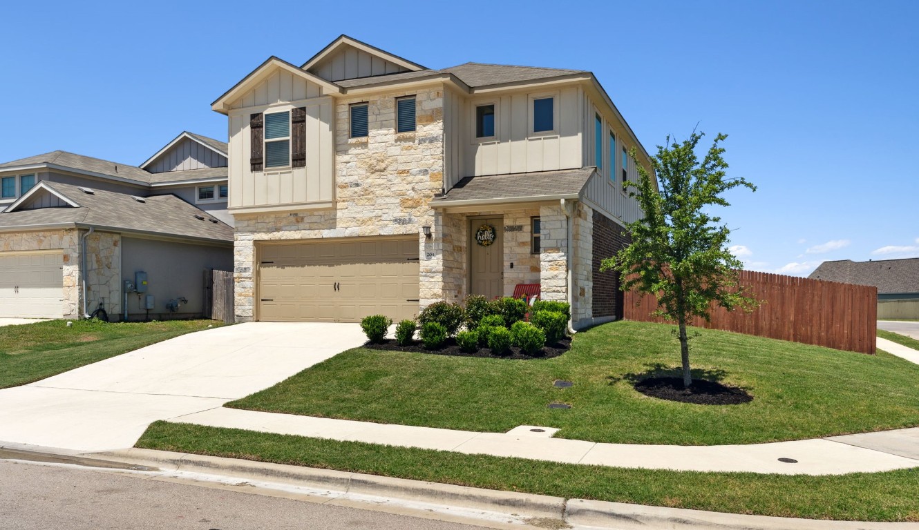 a front view of a house with a yard and garage