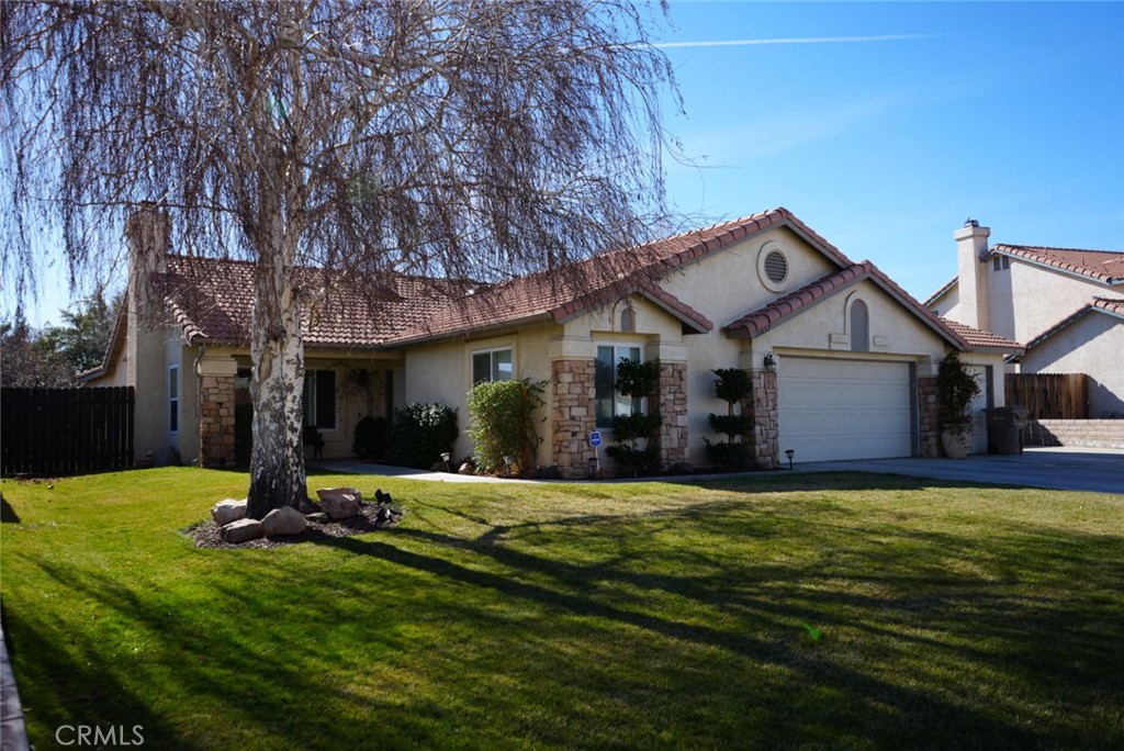 a view of a house with a yard and tree s