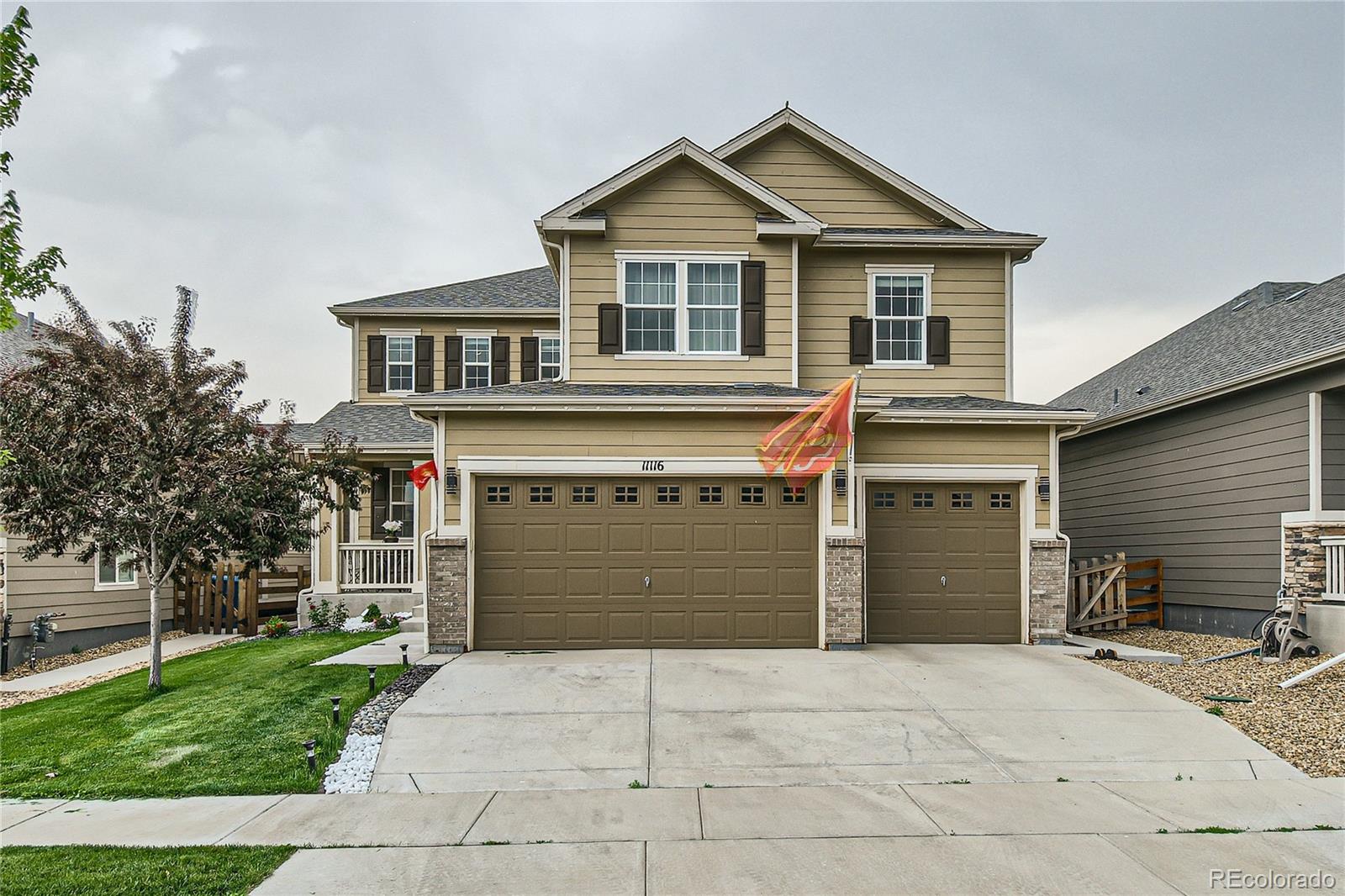 a front view of a house with a yard and garage