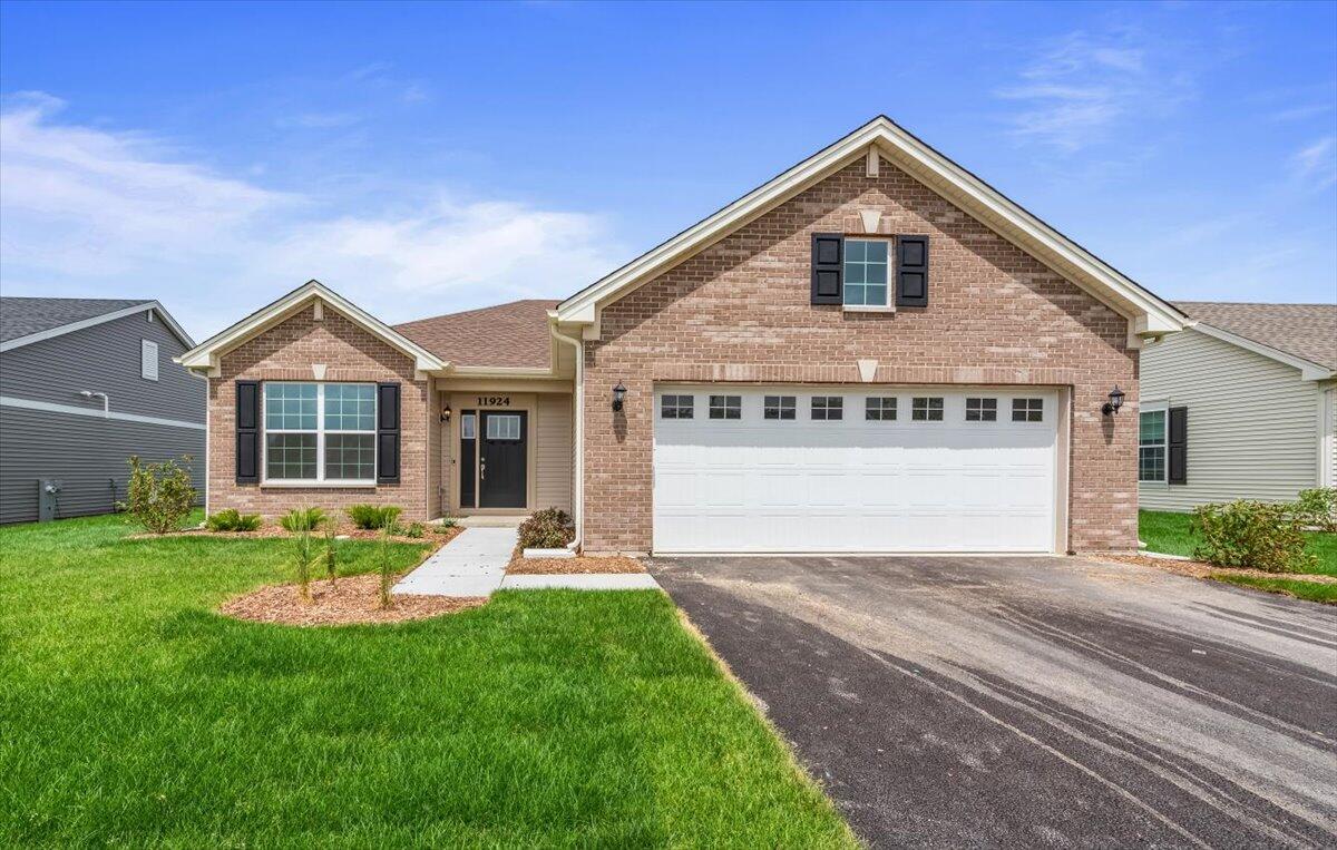 a front view of a house with a yard and garage