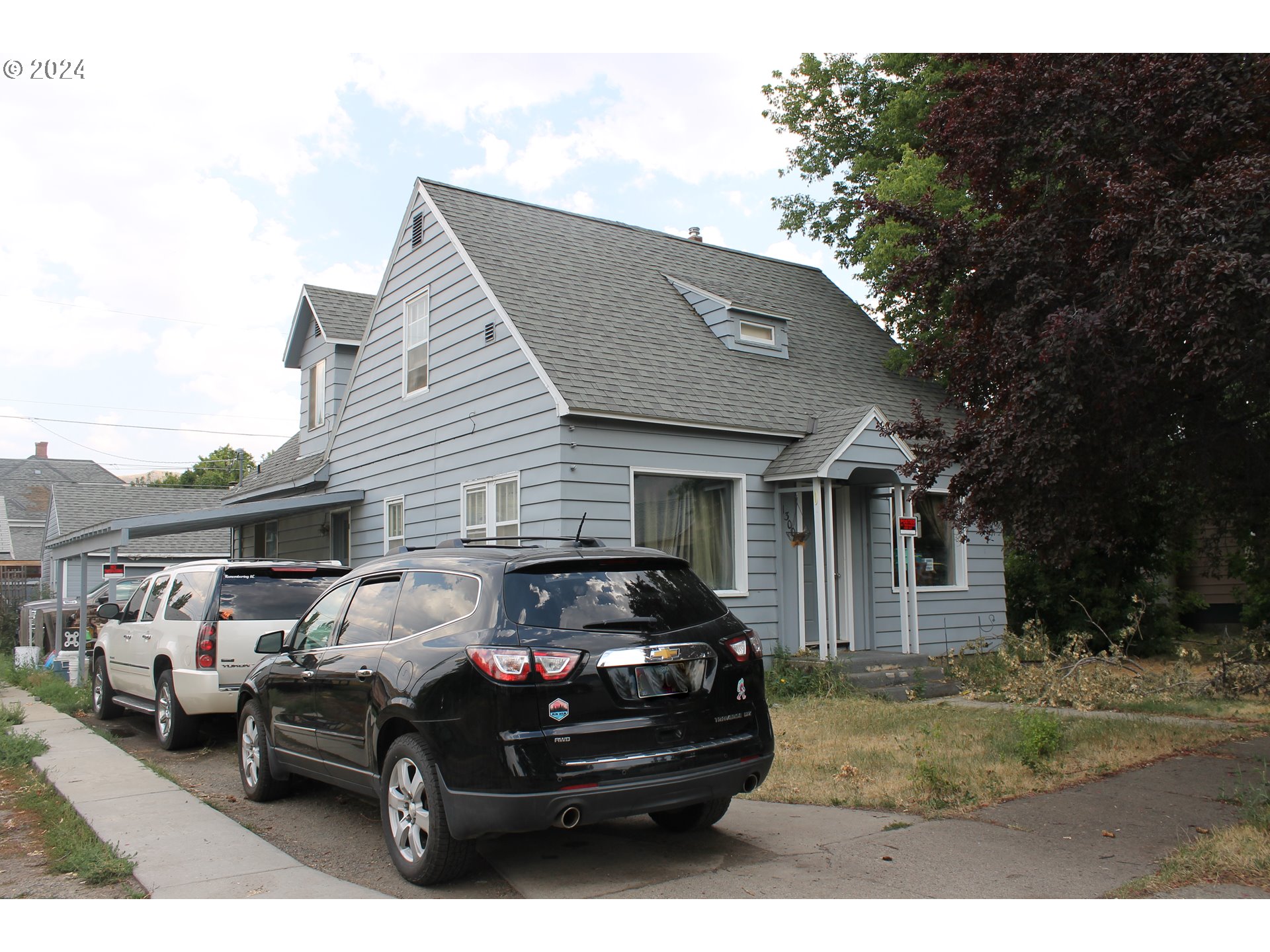 a view of a car parked in front of a house