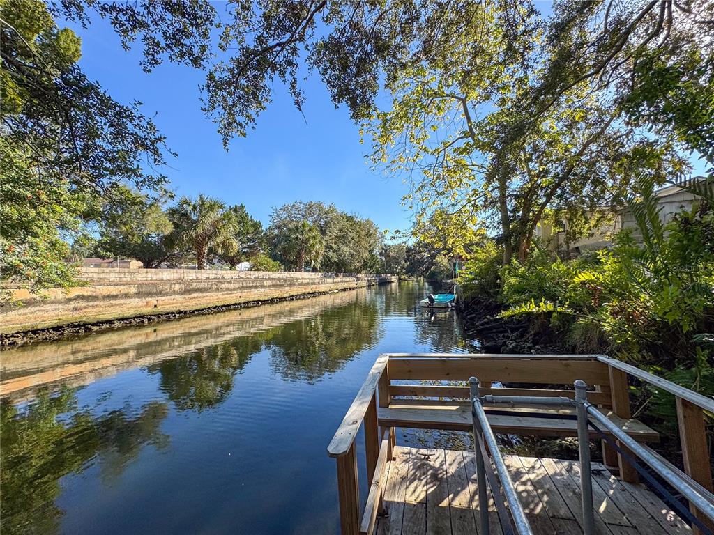 a view of a lake with a yard from a balcony