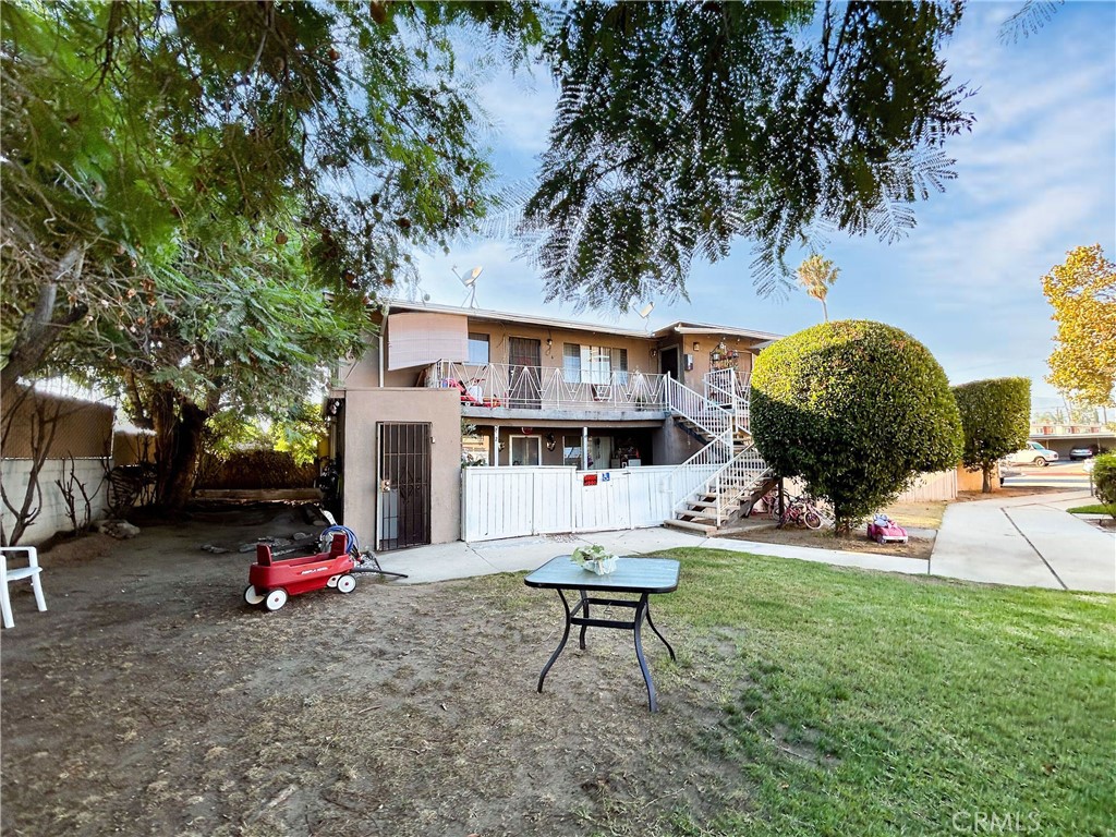 a backyard of a house with barbeque oven table and chairs