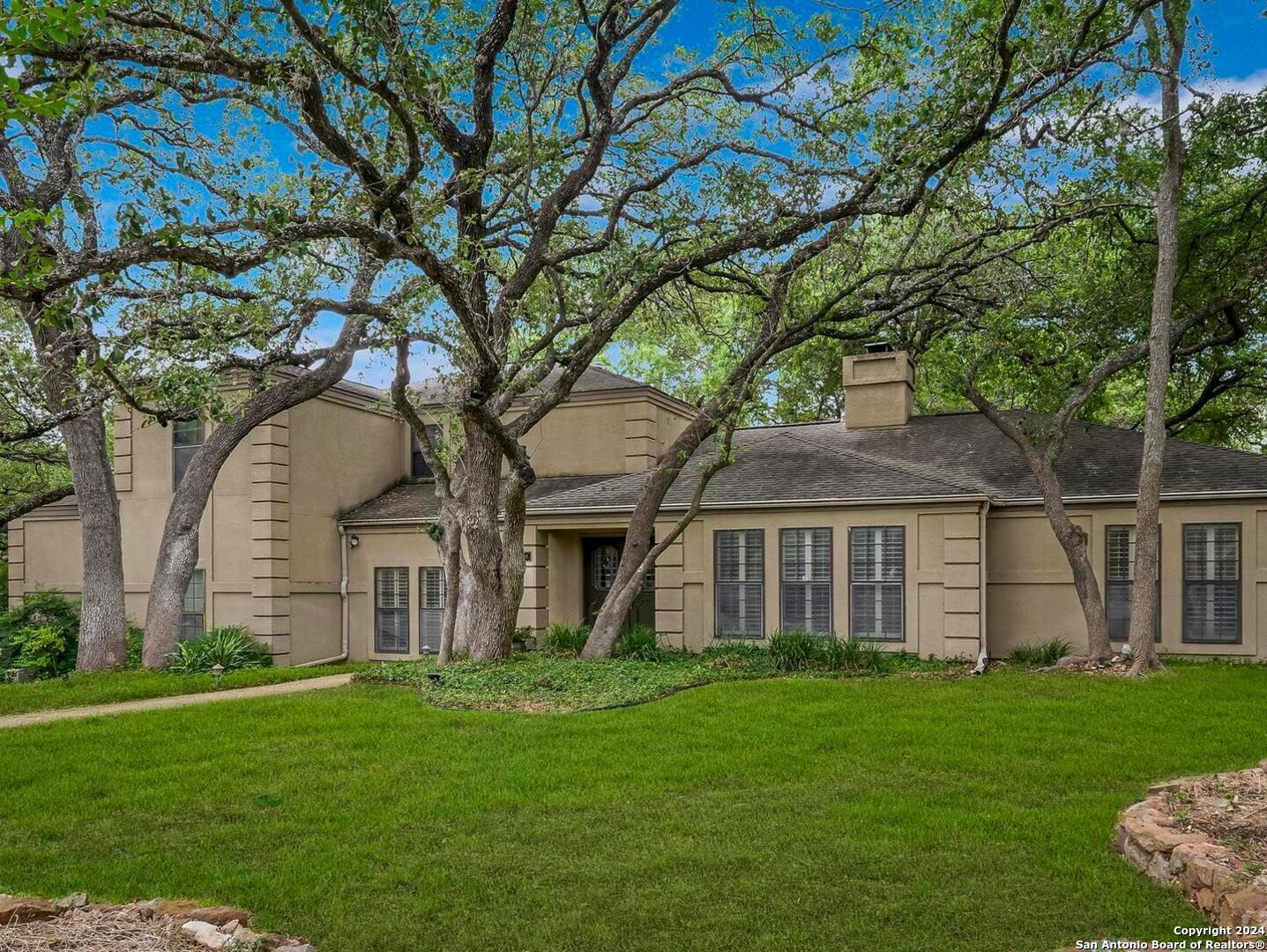 a front view of a house with a garden and yard