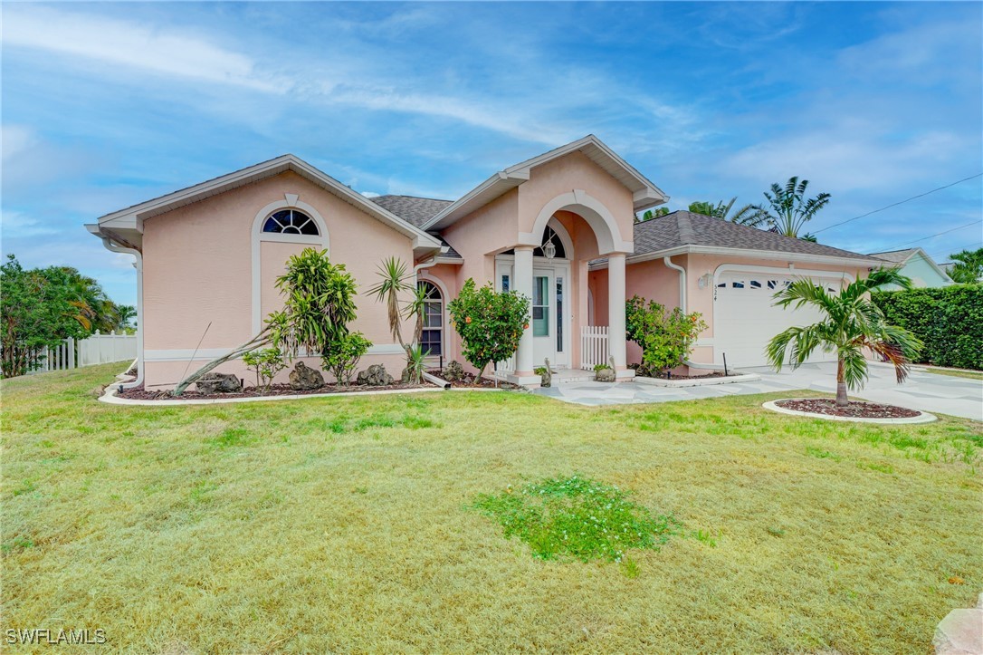 a front view of a house with garden