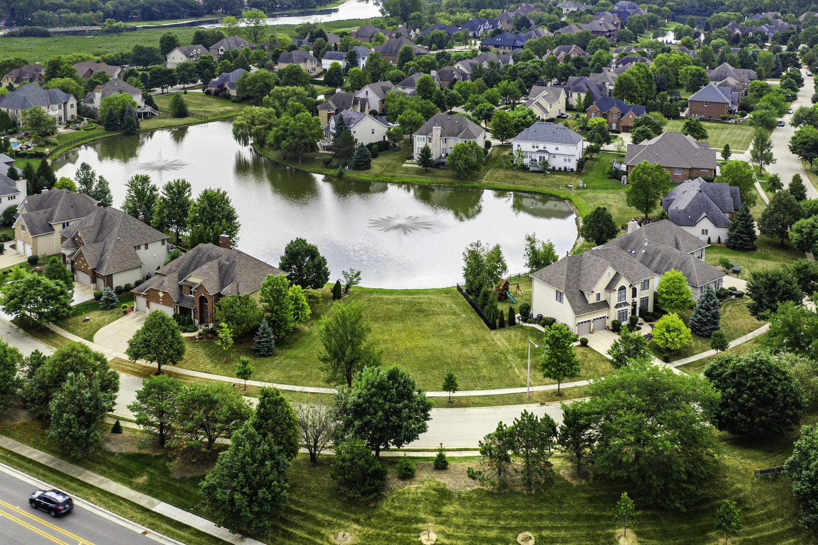 an aerial view of residential houses with outdoor space and swimming pool