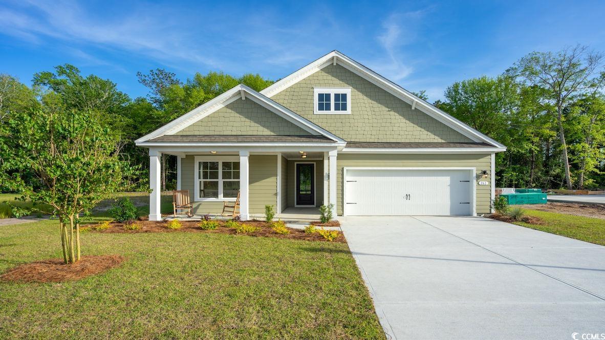 Craftsman-style house with a front yard, a garage,