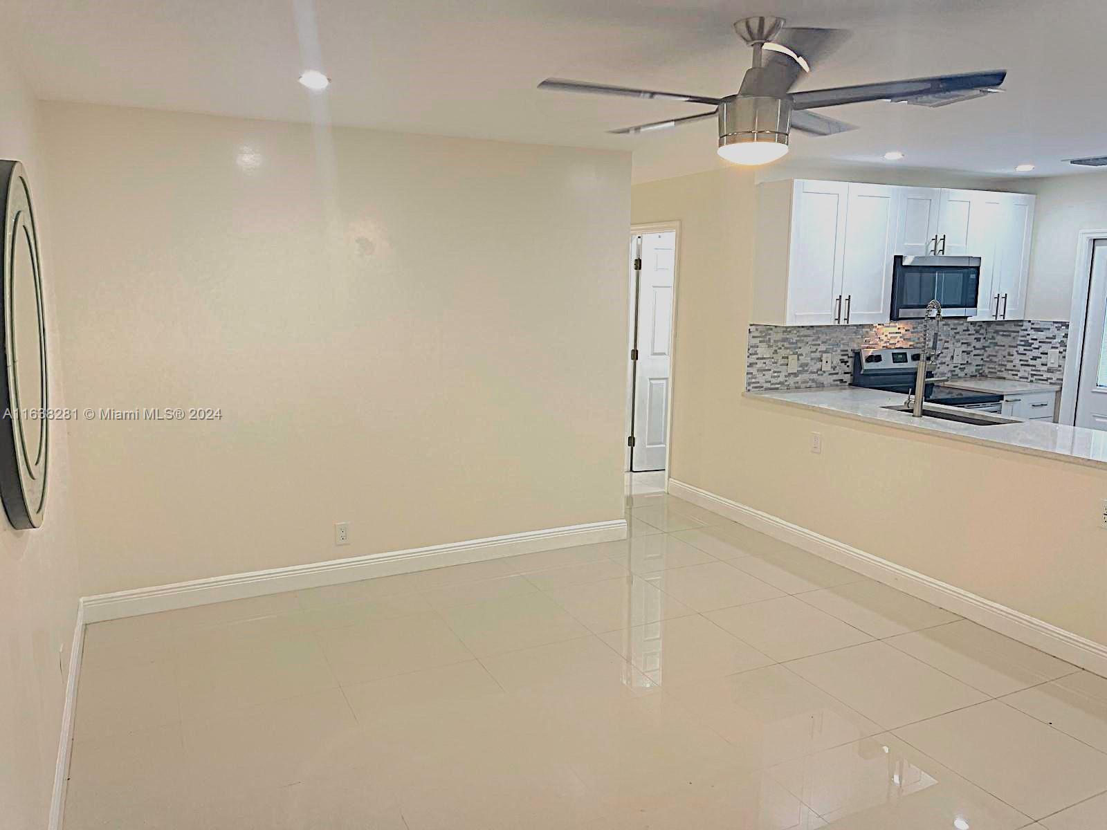 a view of a kitchen with stainless steel appliances a refrigerator