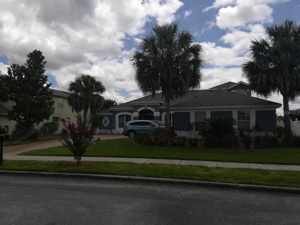 a front view of a house with a garden