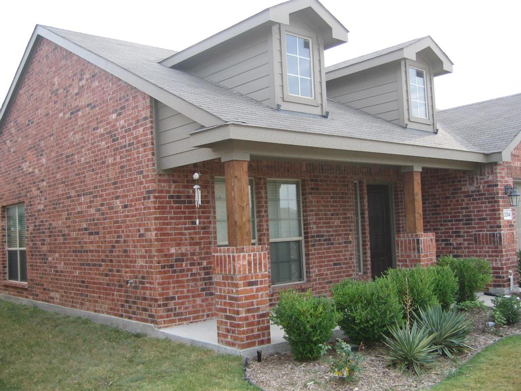 a front view of a house with brick walls