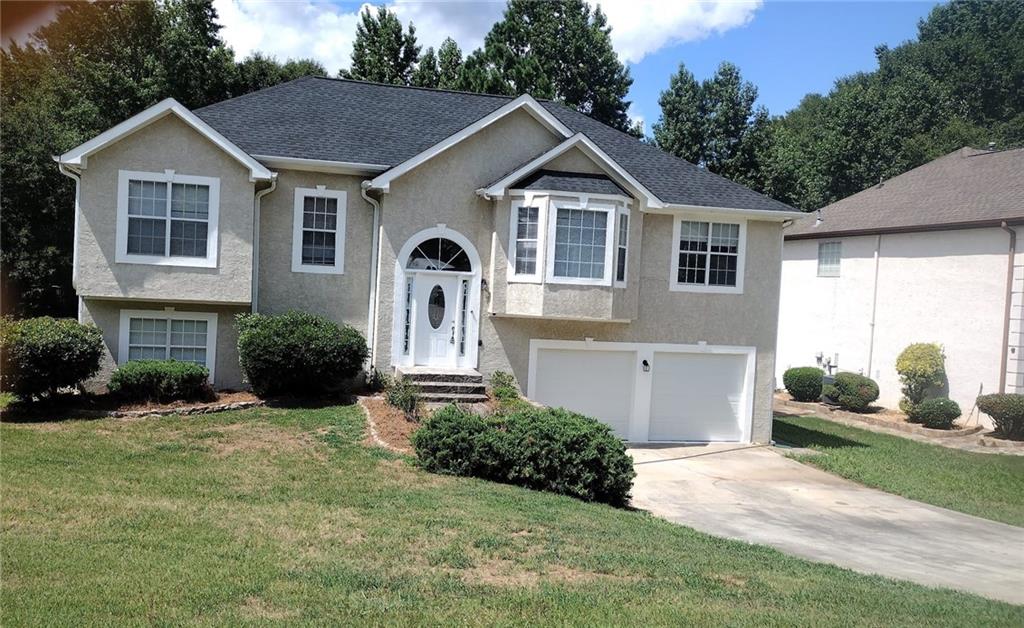 a front view of a house with a yard and garage