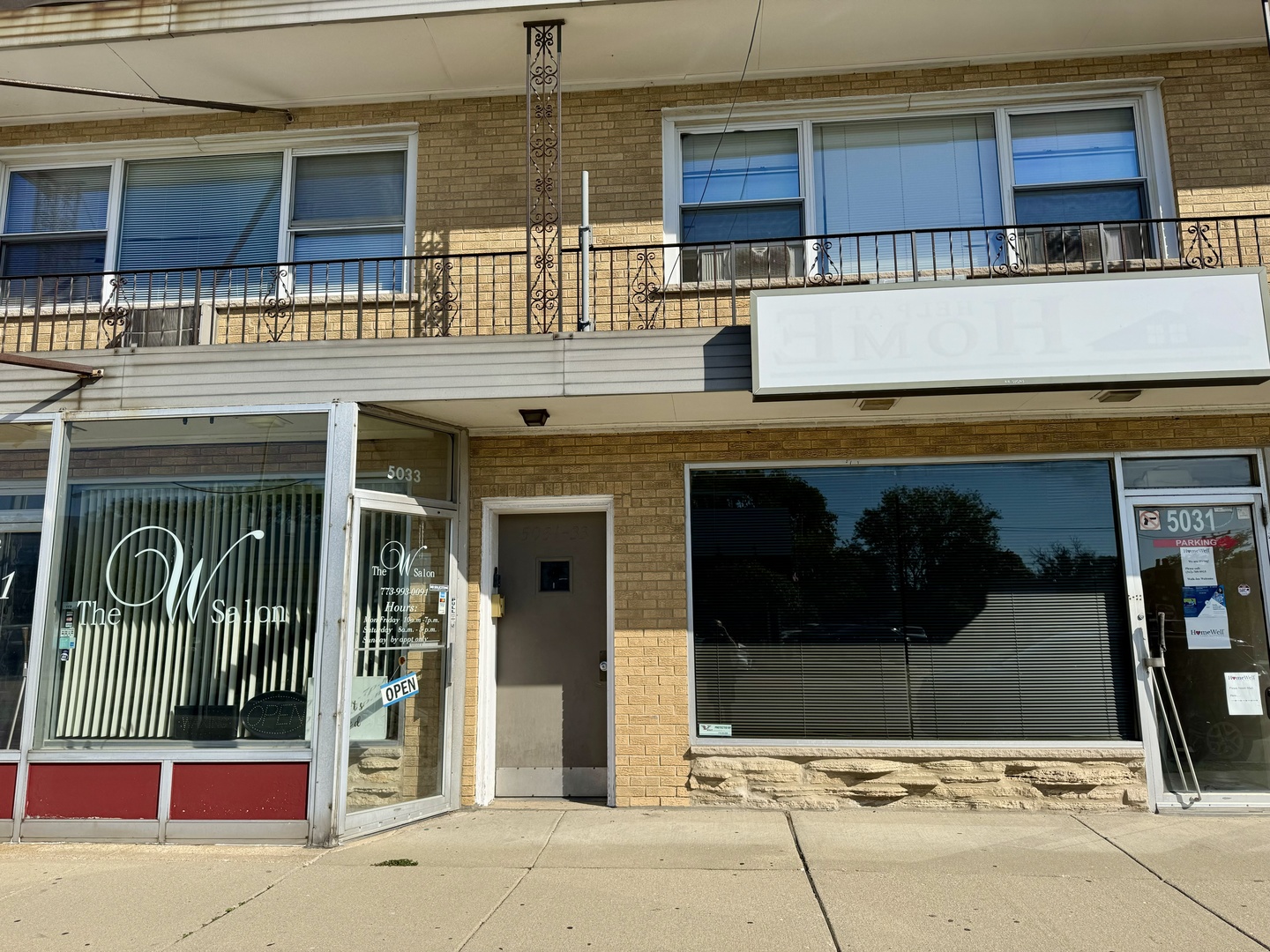 a view of building with glass windows and door