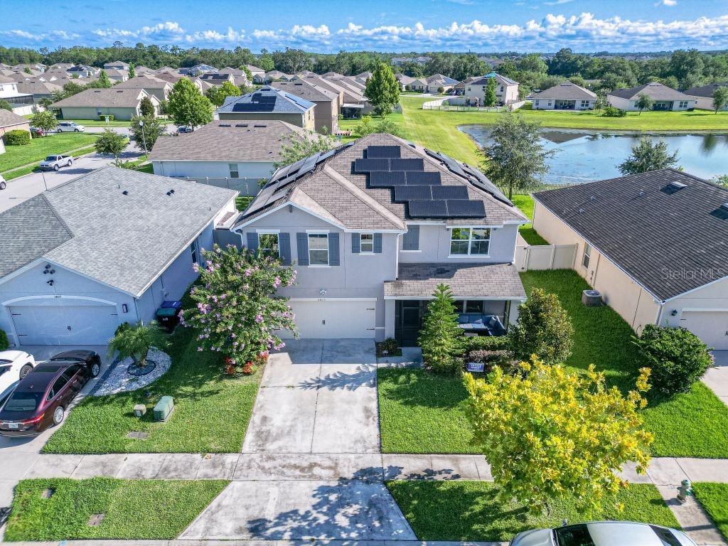 an aerial view of a house with outdoor space and lake view