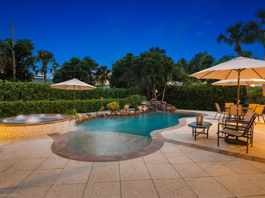 a view of a swimming pool and lounge chair