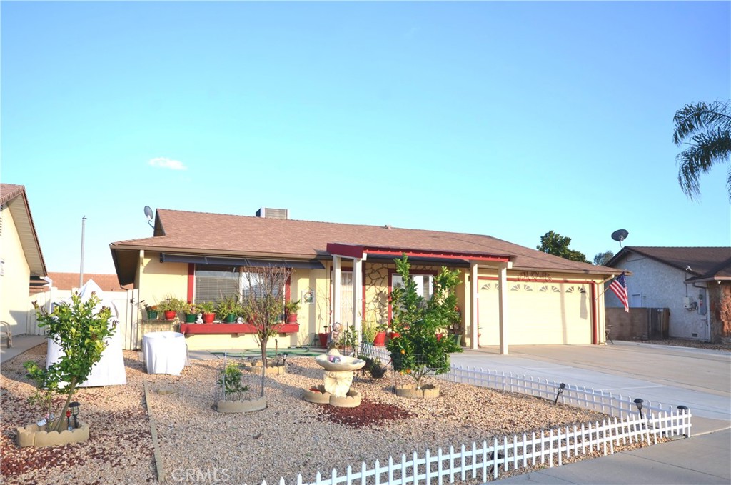 a view of a house with garden and sitting area