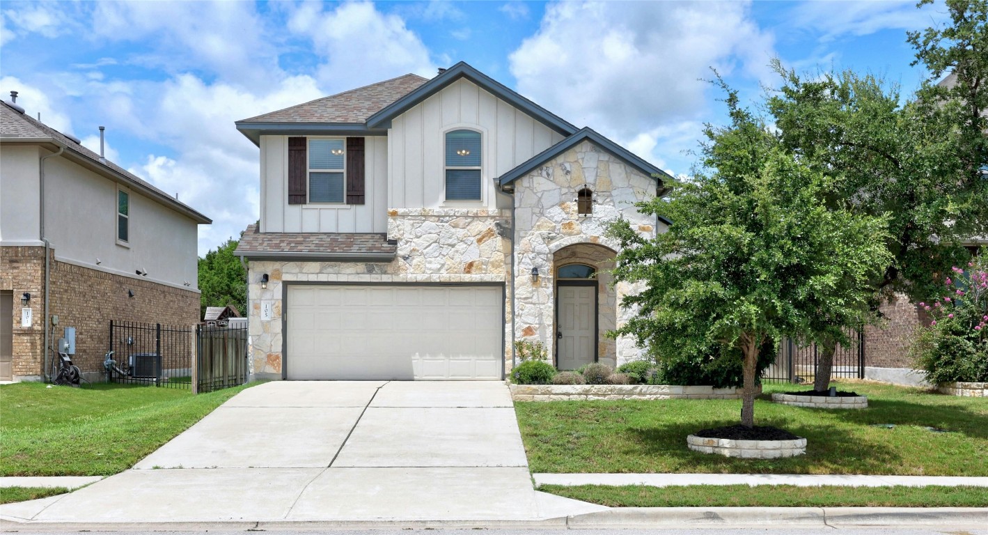 a front view of a house with a yard and trees