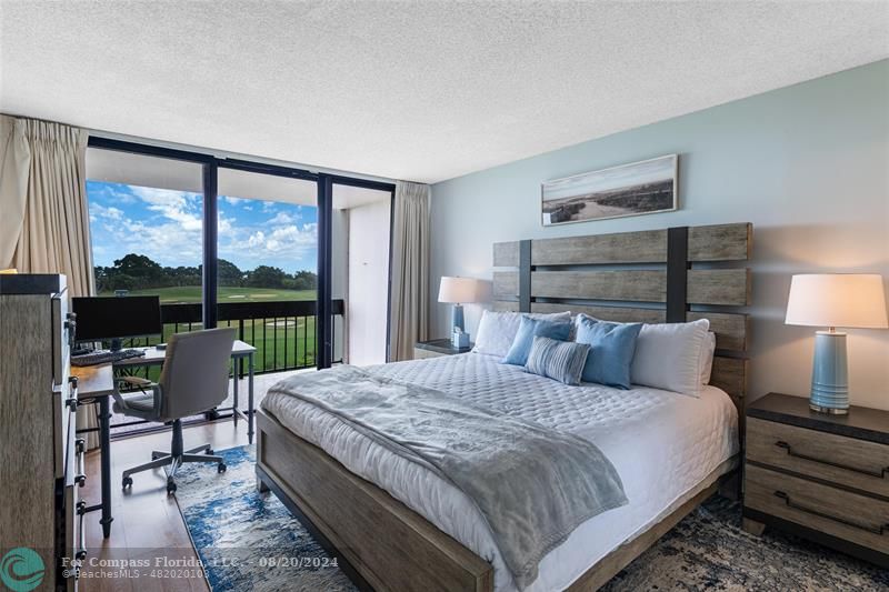 a bedroom with a bed and large window