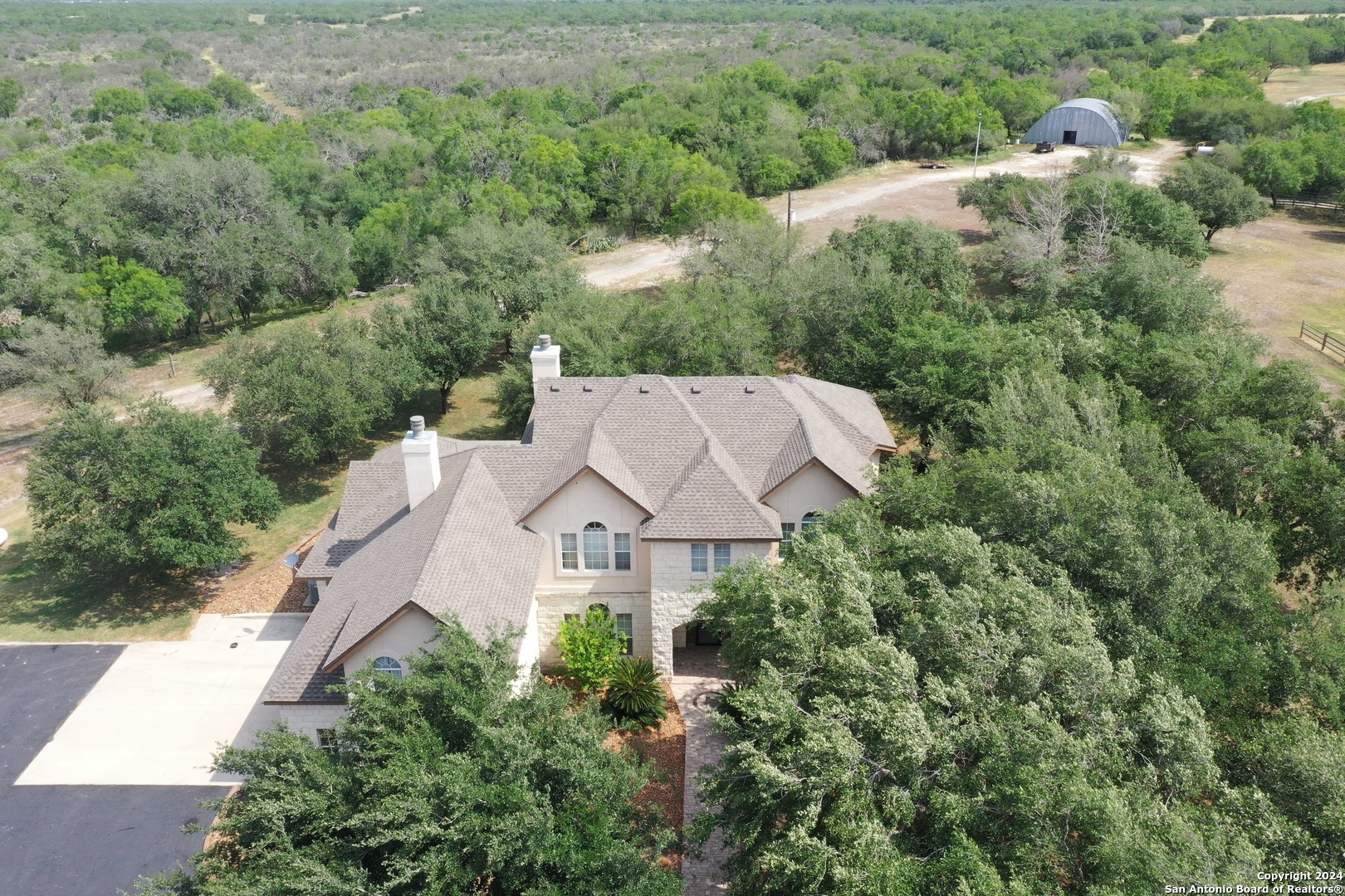 an aerial view of a house with a yard