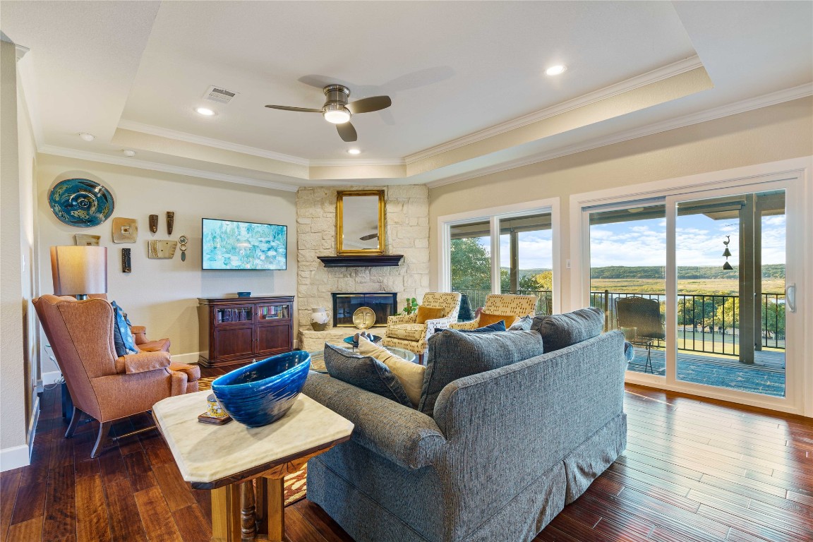 a living room with furniture a fireplace and a floor to ceiling window