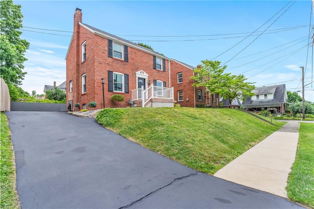 a view of a brick building next to a yard