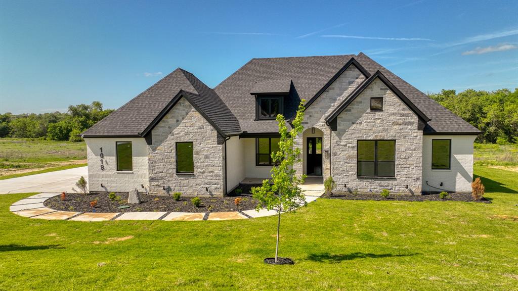 a front view of house with yard and swimming pool