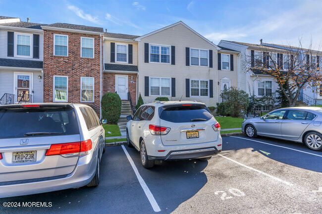 a front view of a house with parking space